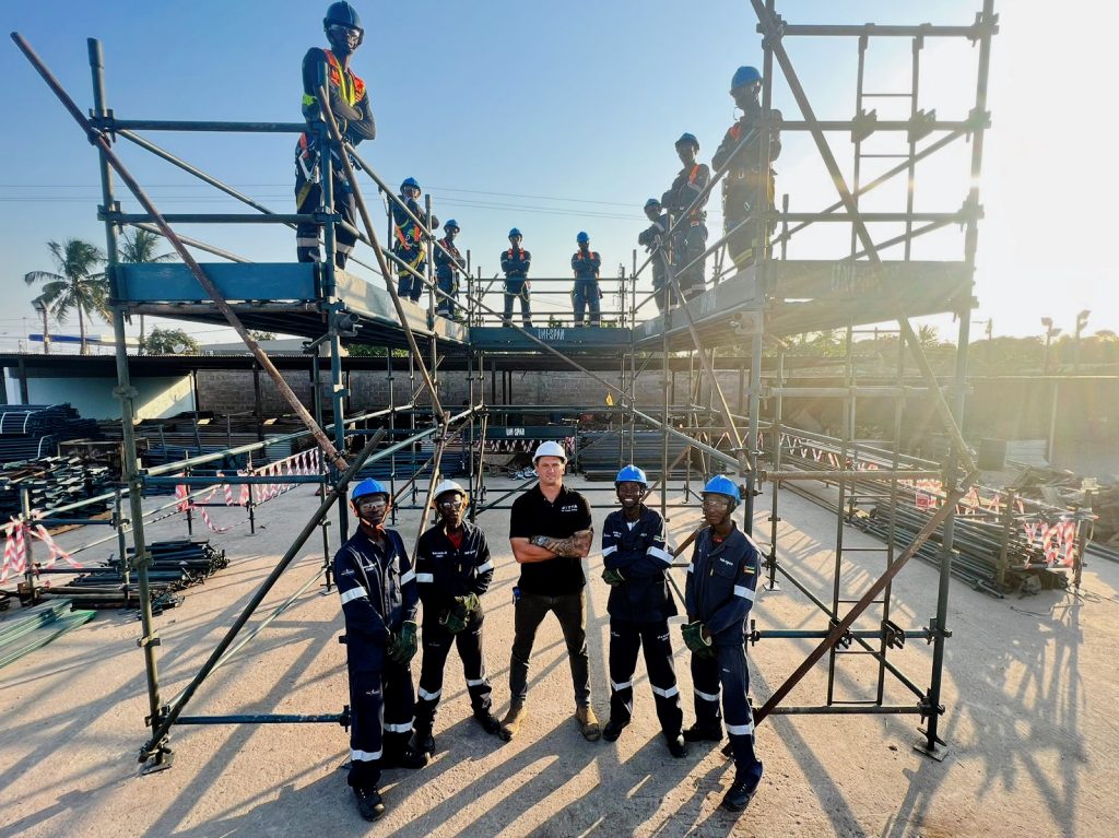 Scaffold trainees and instructors participating in height safety training on a certified training structure